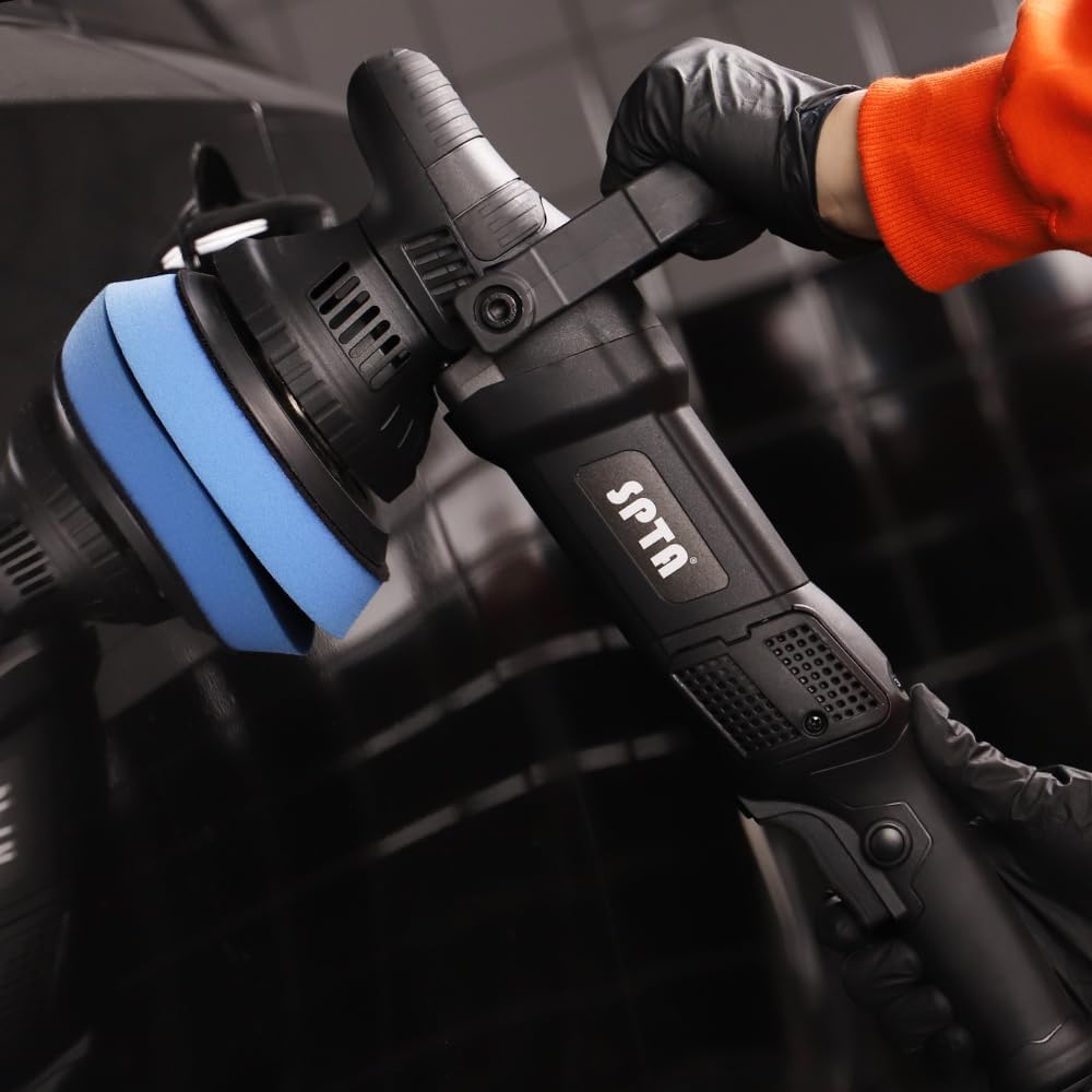 Black SPTA power tool held by a person wearing an orange sleeve.
