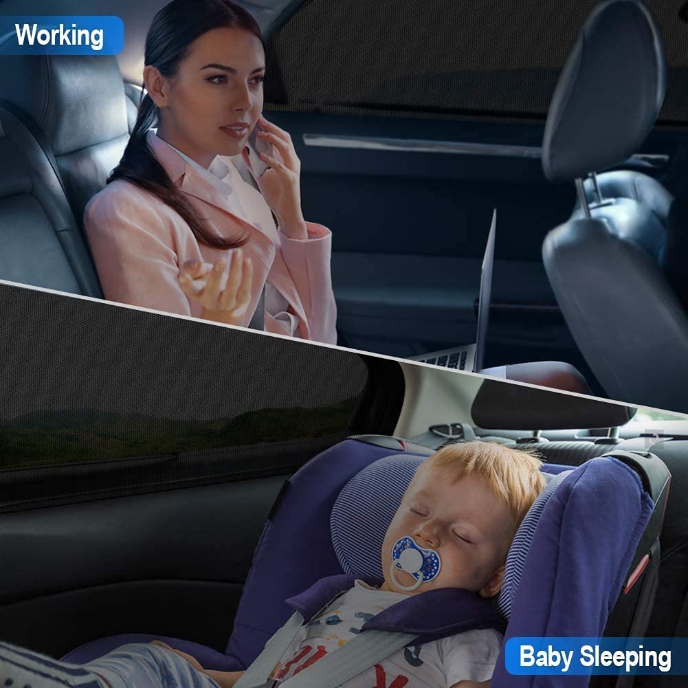 Woman working on a laptop in a car with a baby sleeping in a car seat.