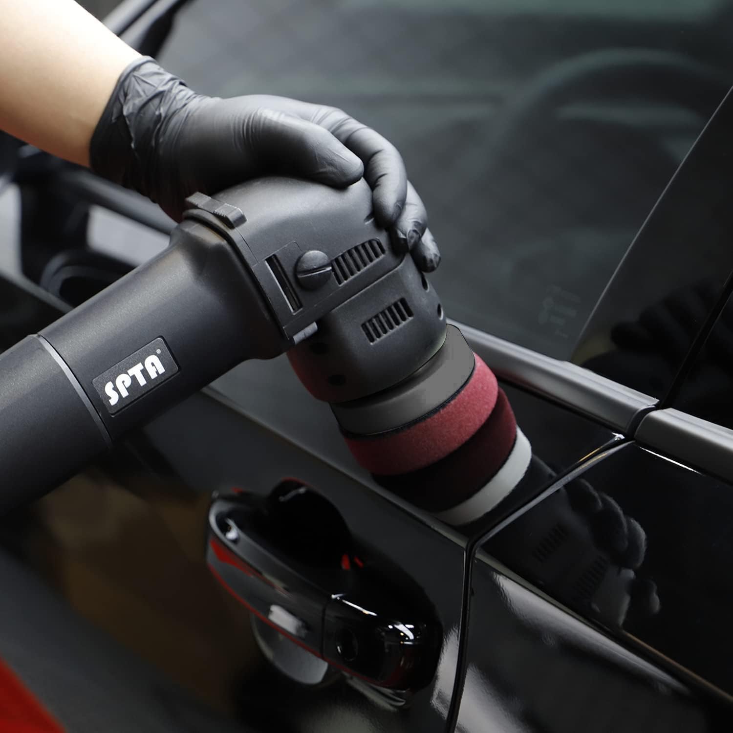 Person using a SPTA car detailing tool on a vehicle.