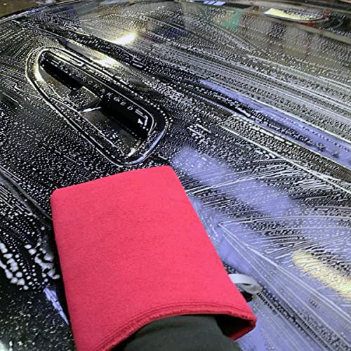 Red microfiber cloth on a car surface with water and soap suds
