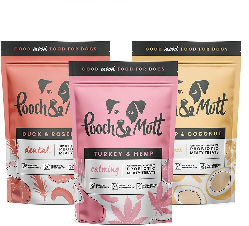 Three packages of Pooch & Mutt dog treats with different flavors on a white background.