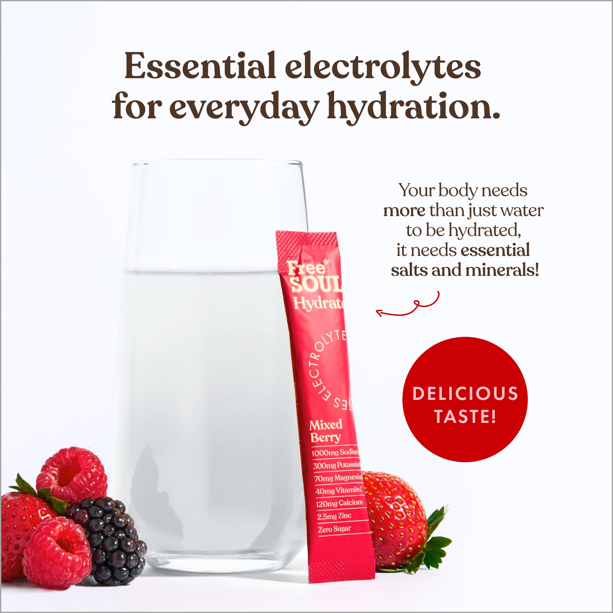 Free Your Soul Hydration Mixed Berry electrolyte stick pack with a glass of water and berries on a white background.