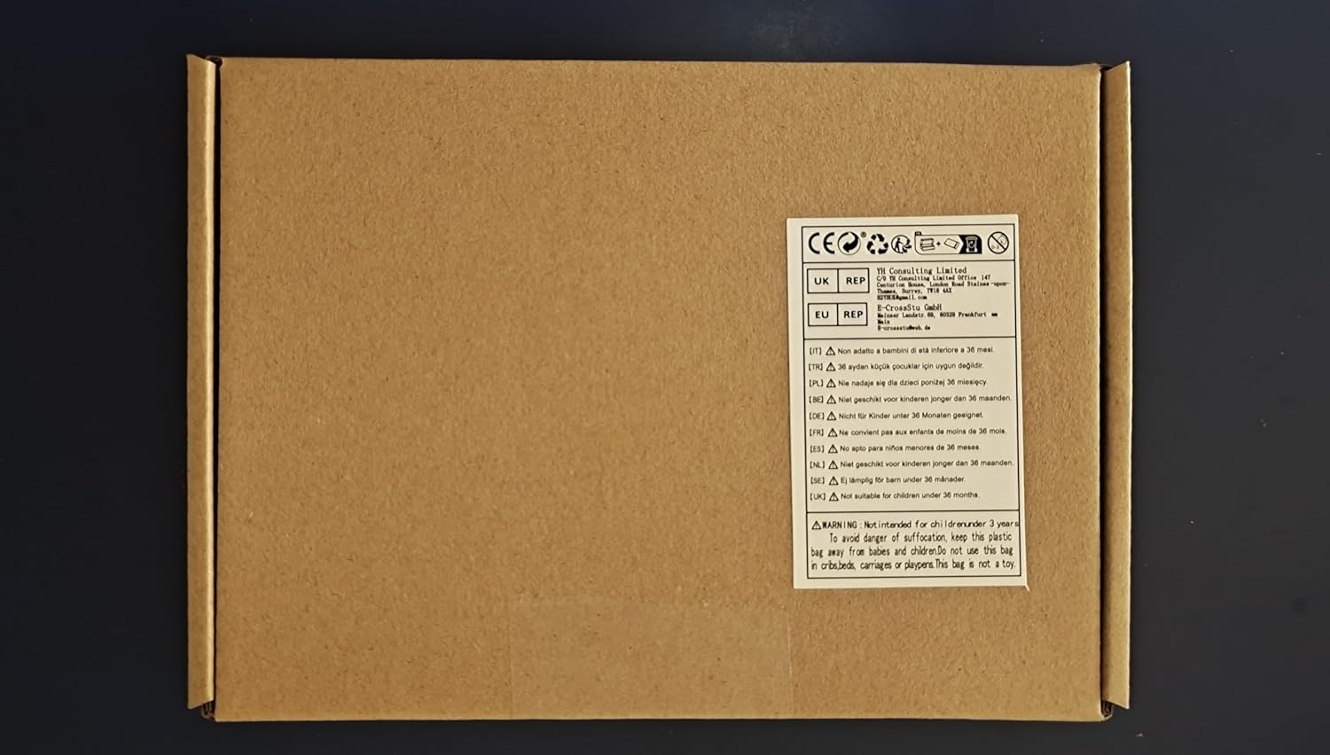 Brown cardboard box with a label on a black background