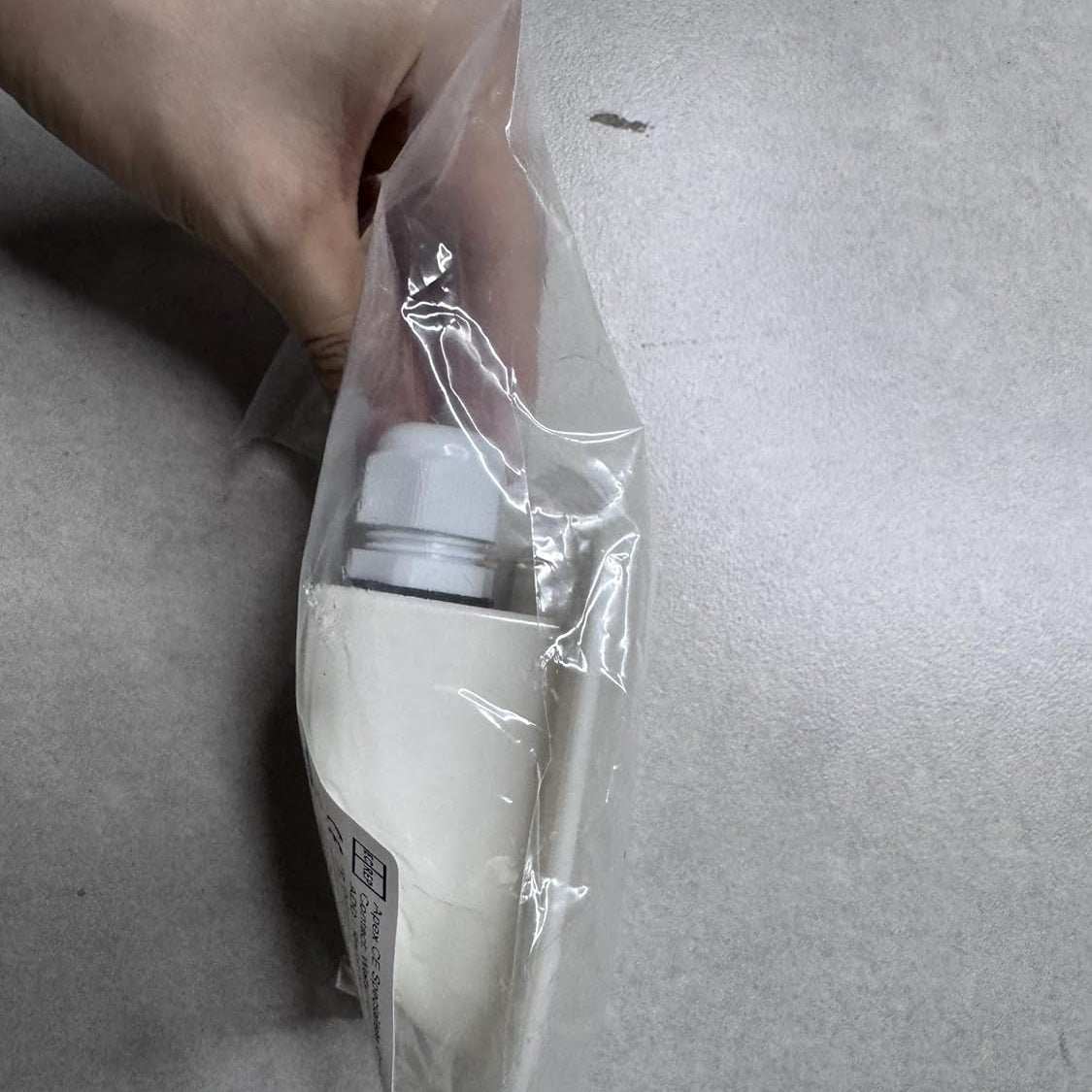 wiring grommet in clear plastic packaging on a grey surface