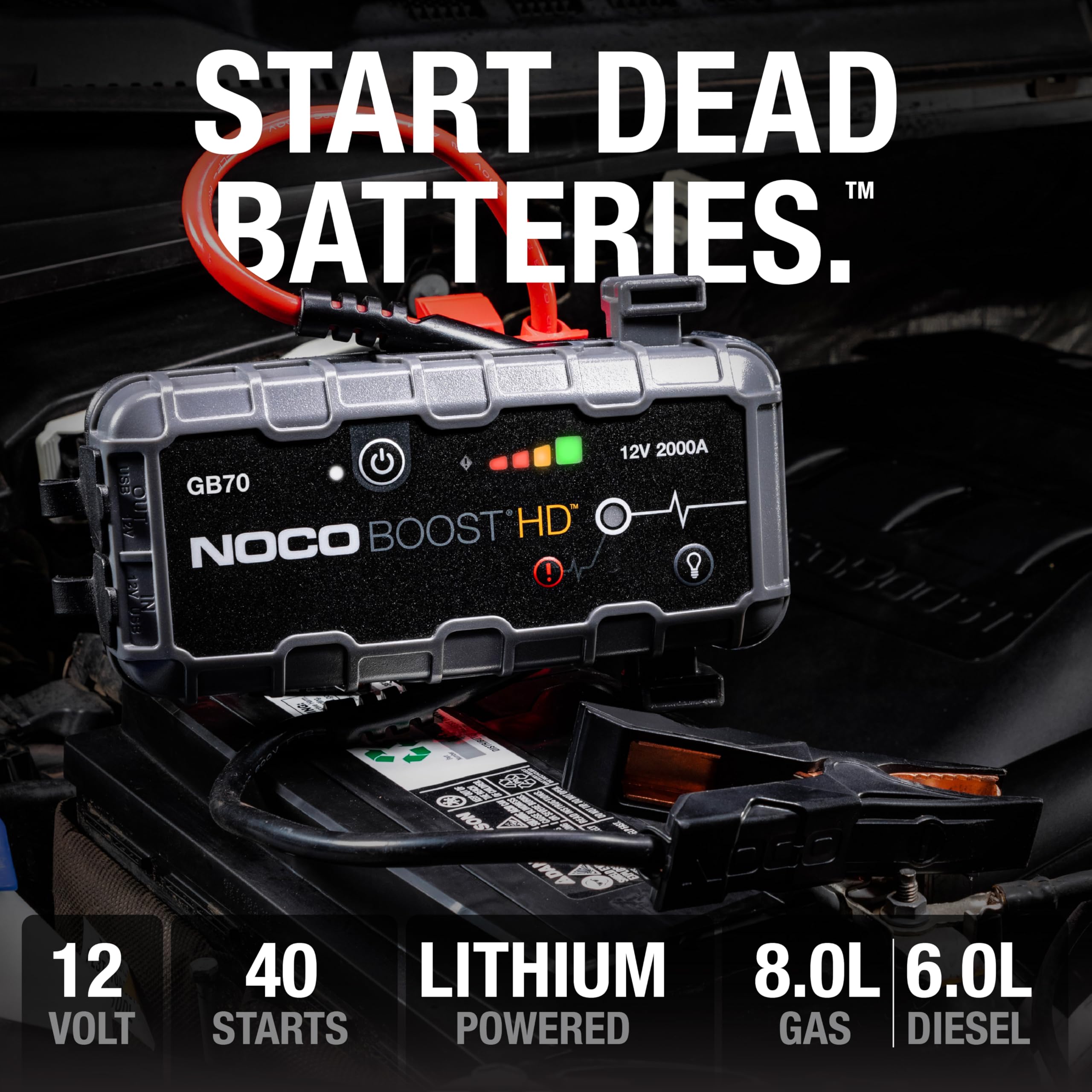 NOCO Boost HD jump starter with battery connection on a dark background