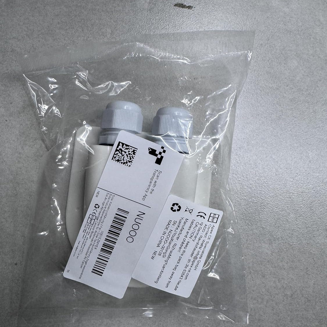 Wiring grommet with labels in a clear plastic bag on a gray surface