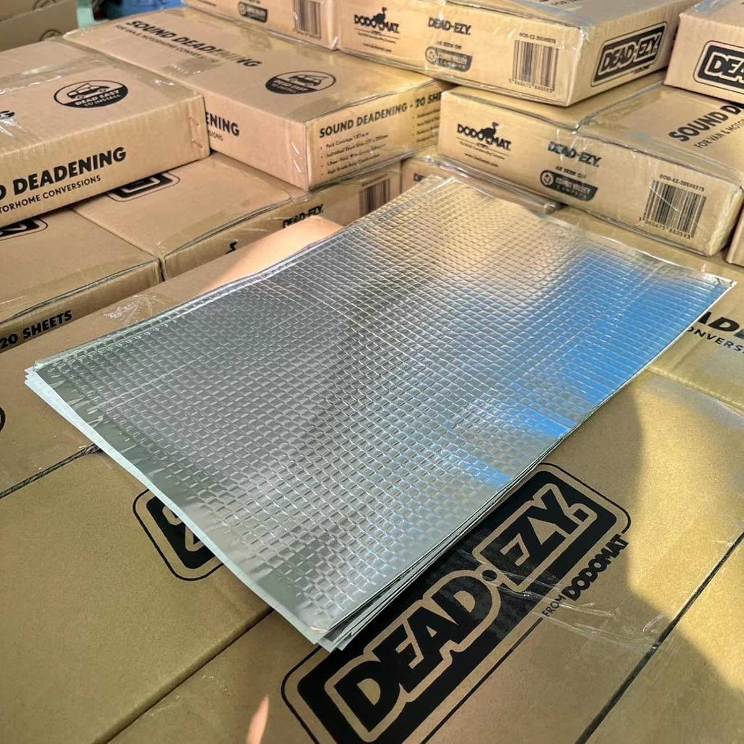 Bubble wrap sheet on top of stacked boxes with 'DEAD EZY' branding.