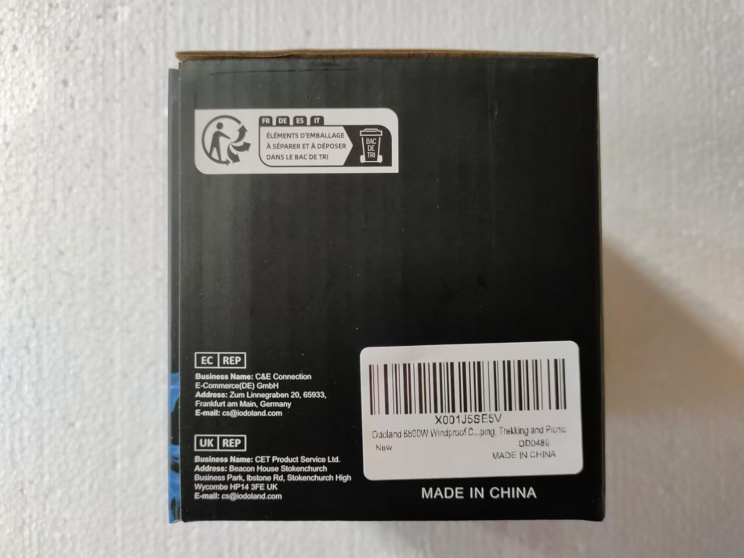 Back view of a black electronic device packaging with labels and text on a white background