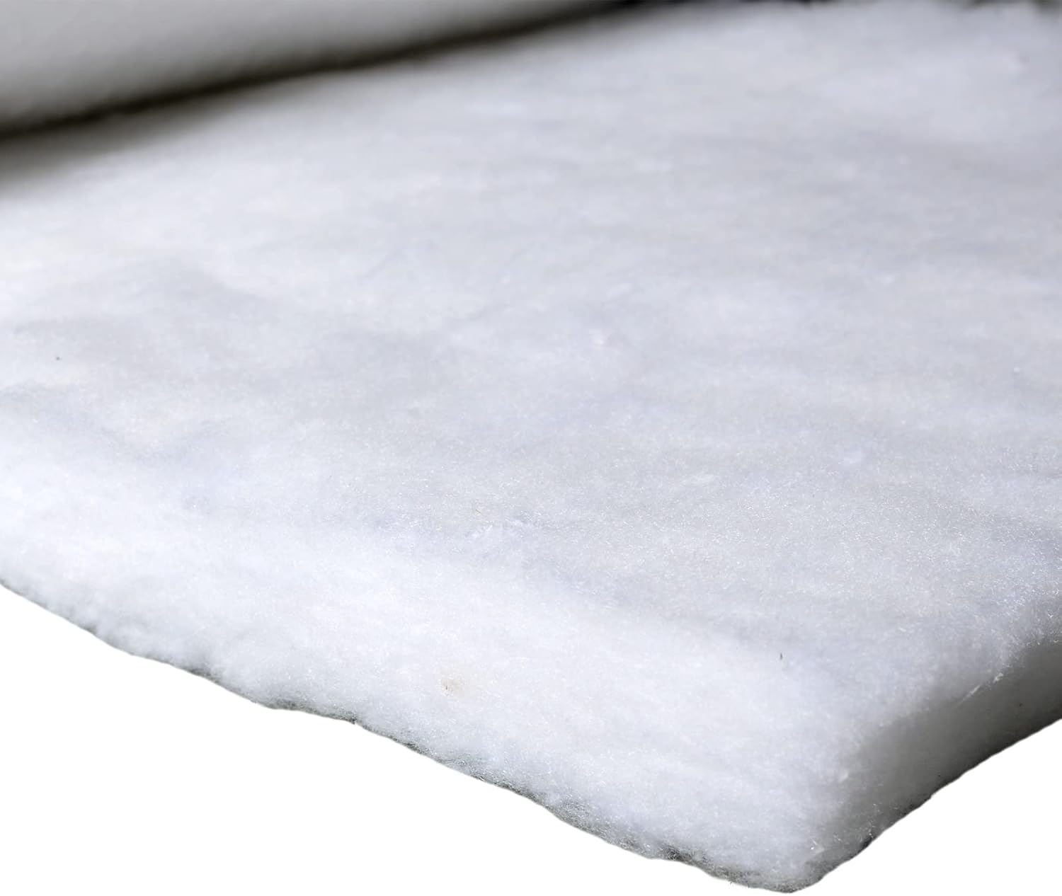 Close-up of white foam padding on a white background