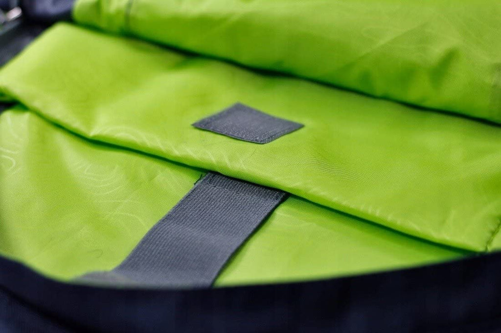 Green fabric with a gray strap and patch on a black background