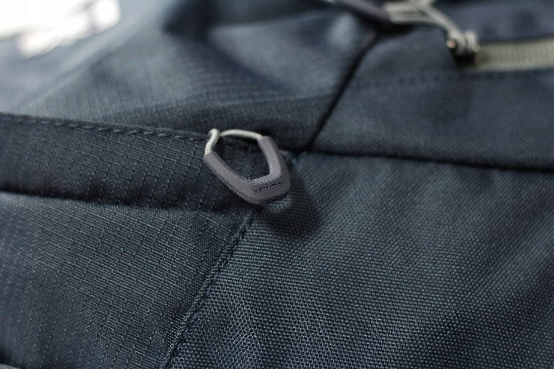 Close-up of a dark blue fabric with a zipper pull, featuring the brand name 'Cotopaxi'.