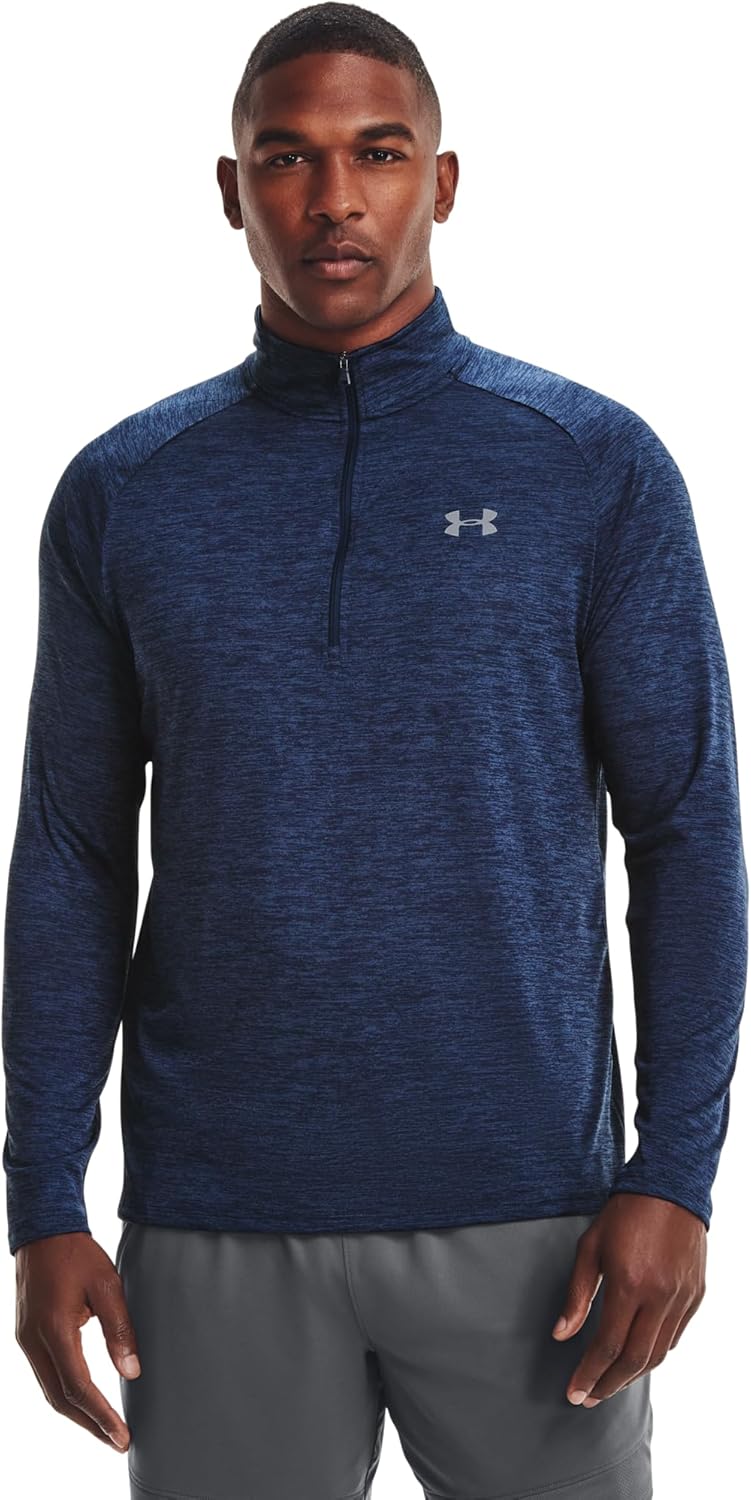 Man wearing a blue long-sleeve athletic shirt with a brand logo on a white background