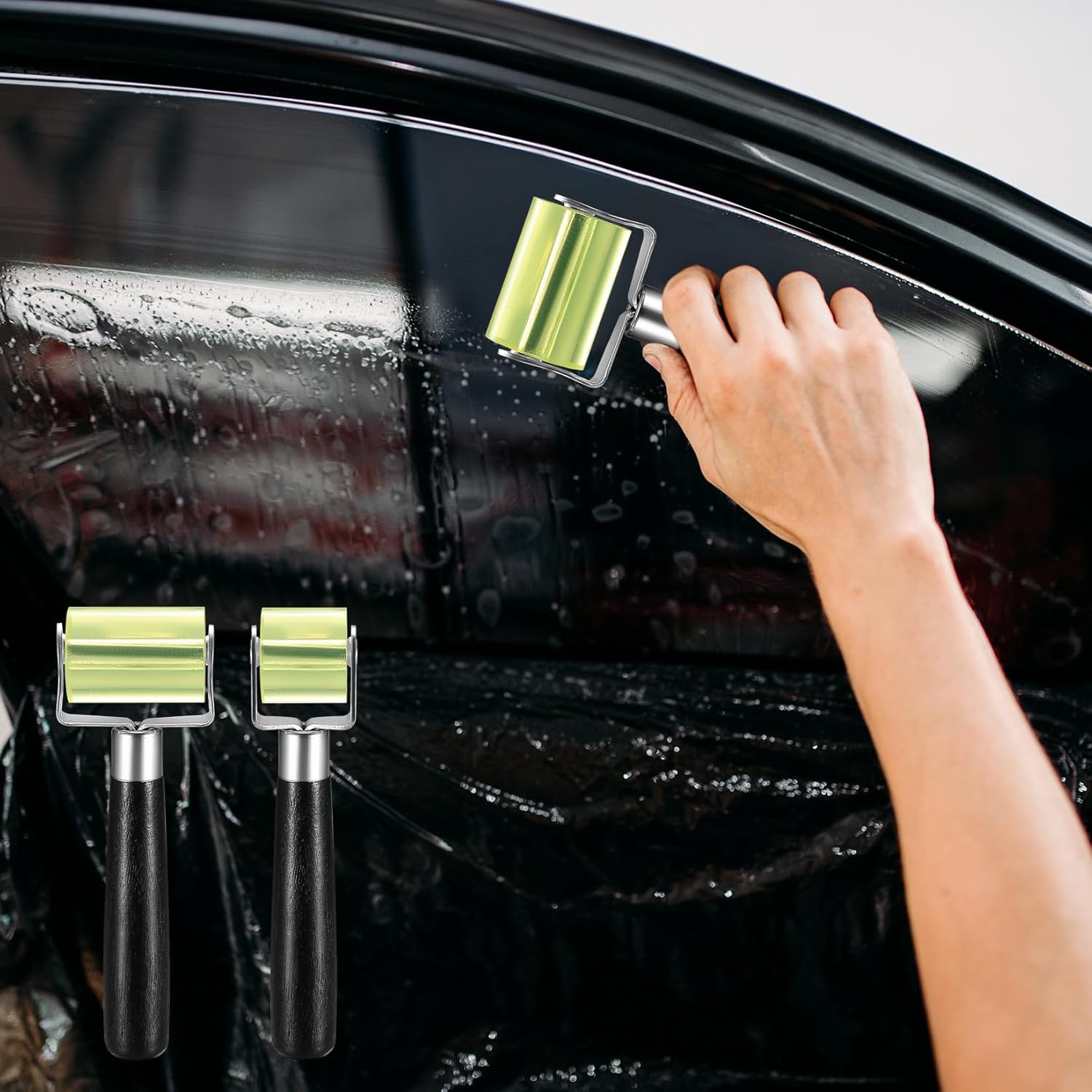 Person using a car window cleaning tool on a car's windshield with additional tools displayed below.