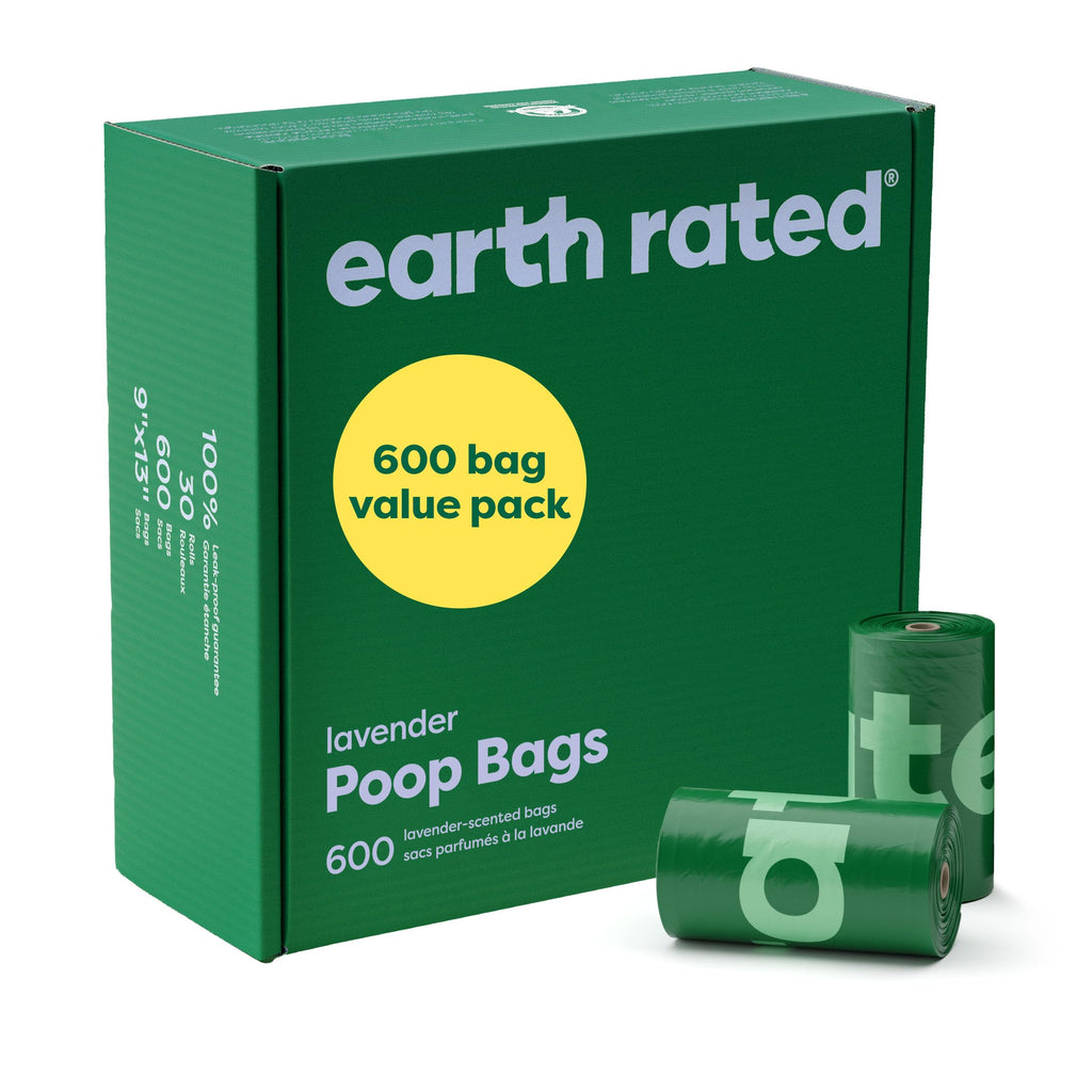 Green box of earth rated lavender poop bags with two rolls in front on a white background